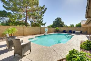 una piscina con sillas y una valla en Chandler Vacation Rental with Saltwater Pool!, en Chandler