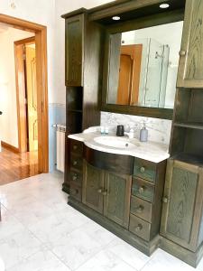 a bathroom with a sink and a mirror at Casa da Pedra Guest House in Torres Vedras