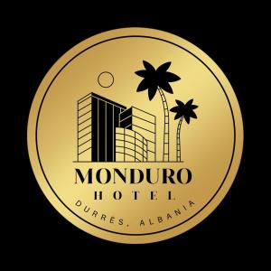 a gold coin with a palm tree and a hotel at MondurO Hotel in Durrës