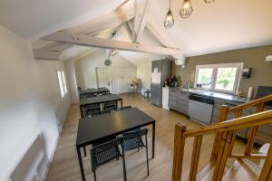 a kitchen with tables and chairs in a room at Domaine le Colombier in Dienville