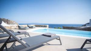 a villa with a swimming pool next to the ocean at Elia Spirit Villas and Suites by Live&Travel in Elia Beach