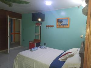 Łóżko lub łóżka w pokoju w obiekcie Hotel Pueblito Playa