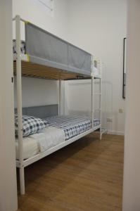 a bunk bed in a room with a wooden floor at La Dimora dell'Arcivescovo in Bari