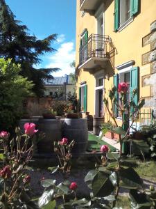 a building with pink roses in front of it at Agritur Tenno Bio Natura in Tenno