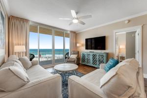 a living room with a couch and a tv and a table at Waterscape A V in Fort Walton Beach