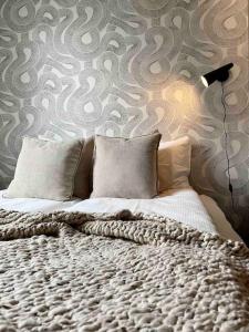 a bedroom with a large bed with a patterned wall at Private Lux 2BR & 2BA City Center with Free Parking in Reykjavík