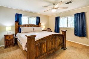 1 dormitorio con cama grande de madera y cortinas azules en Waterfront Monkey Island Vacation Rental with Deck, en Afton
