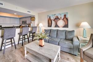 a living room with a couch and a table at Myrtle Beach Condo with Community Pool and Ocean Views in Myrtle Beach