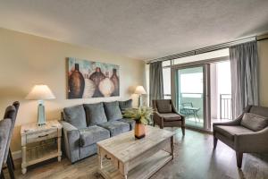 a living room with a couch and a table at Oceanfront Myrtle Beach Condo with Pools and Hot Tubs in Myrtle Beach