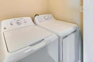a white washer and dryer in a laundry room at Myrtle Beach Condo with Community Pool and Ocean Views in Myrtle Beach