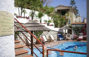 una piscina con sillas y una persona en el agua en Hotel Barsalini en SantʼAndrea