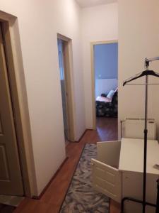a living room with a couch and a room with a bed at Apartman Katarina in Vranje
