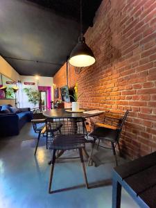 a dining room with a brick wall and a table and chairs at Industrial Cozy Gzira Apt, Prime Spot, Sep Deal in Il-Gżira
