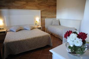 Postel nebo postele na pokoji v ubytování Hotel Barsalini