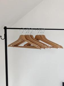 a rack with wooden hangers in a room at Bel-etage Bruges Homestay - Free parking - Entire floor in Bruges