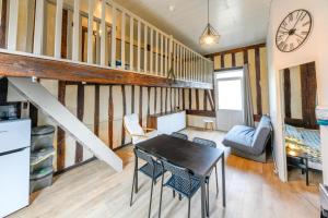 a kitchen and dining room with a table and chairs at Domaine le Colombier in Dienville