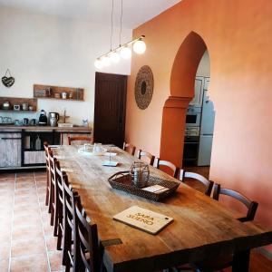 a large wooden table in a room with a kitchen at B&B Sara Sueño in Málaga