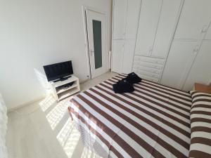 a bedroom with a bed and a television at Casa Patrizia by PortofinoVacanze in Rapallo