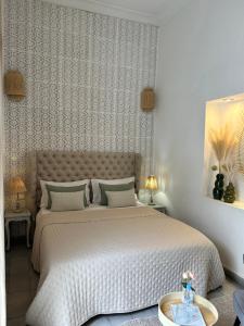 a bedroom with a large bed in a room at Riad Villa Wengé & Spa in Marrakech