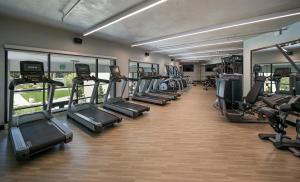 a gym with rows of treadmills and elliptical machines at Le Meridien Pasadena Arcadia in Arcadia