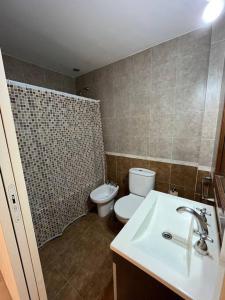 a bathroom with a white toilet and a sink at Naon in Buenos Aires