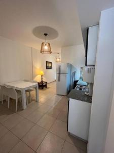 a kitchen with a white table and a white refrigerator at Naon in Buenos Aires