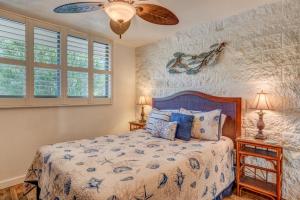 a bedroom with a bed and a ceiling fan at Kanai A Nalu 210 in Wailuku +24 photos