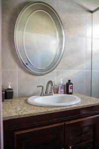a bathroom sink with a large mirror above it at Pawadi Nou in Augier