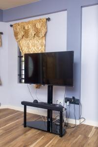 a flat screen tv on a stand in a living room at Pawadi Nou in Augier