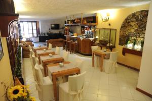 a restaurant with tables and chairs in a room at Hotel Barsalini in SantʼAndrea