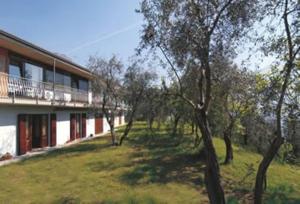 a building with a yard with trees next to it at Appartamento BeB Preone CIR17089BEB01 in Limone sul Garda