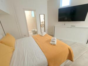 a bedroom with a bed and a flat screen tv at L’angolo del bosco in Naples