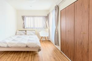 Tempat tidur dalam kamar di 駒込駅徒歩7分/旧古河庭園至近(100m)の4LDKマンション「92m2」