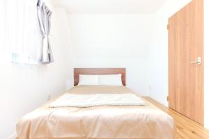Tempat tidur dalam kamar di 駒込駅徒歩7分/旧古河庭園至近(100m)の4LDKマンション「92m2」