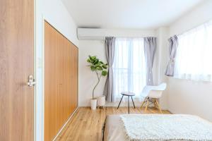 Tempat tidur dalam kamar di 駒込駅徒歩7分/旧古河庭園至近(100m)の4LDKマンション「92m2」
