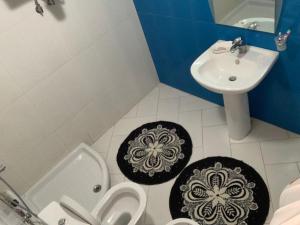 a bathroom with a sink and a toilet and a sink at Lula Guesthouse in Gjirokastër