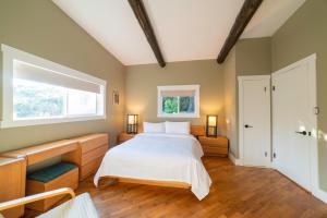 a bedroom with a large bed and a window at Cozy Cabin Suites, Sooke, Bc in Sooke