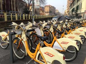 a bunch of bikes parked in a row on a street at Lovelyloft Navigli - Gelsomino in Milan