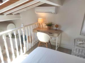 a bedroom with a staircase with a desk and a chair at Chill Out Cabanon Coeur Calanques in Marseille