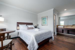 a bedroom with a bed and a bathroom with a sink at Crewe Boutique Inn in Crewe +25 photos