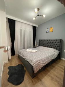 a bedroom with a bed with two towels on it at DAF apartaments in Pristina