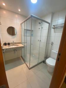 a bathroom with a glass shower and a toilet at Vila beija-flor prime / apt 02 in Mucugê