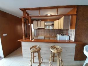 a kitchen with a counter and two stools at App Mladenka in Novigrad Istria