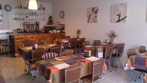 a restaurant with tables and chairs and a kitchen at Flor Do Douro - Comércio e Hotelaria, Lda in Miranda do Douro