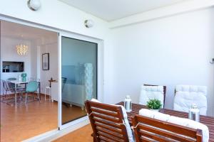 a living room and dining room with sliding glass doors at Cabanas Sea View APT in Golden in Cabanas de Tavira