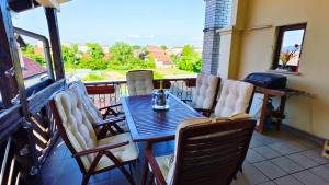 a table and chairs on a balcony with a view at Family apartment 'Sofia' in Brežice