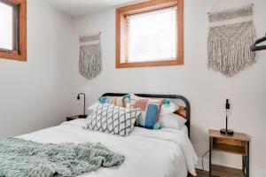 a bedroom with a bed and two windows at Prime Location! Cozy Home in Church Hill/Shockoe in Richmond