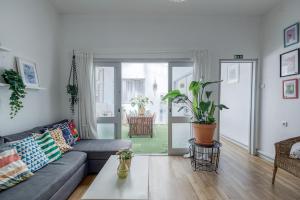 a living room with a couch and a table at Travel & Live Porto Hostel in Porto