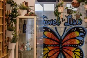 a glass door with a butterfly painted on it at Travel & Live Porto Hostel in Porto