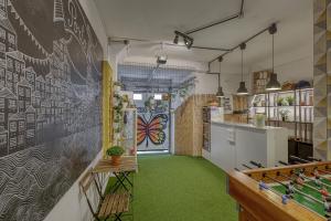 a kitchen with a chalkboard wall and green carpet at Travel & Live Porto Hostel in Porto